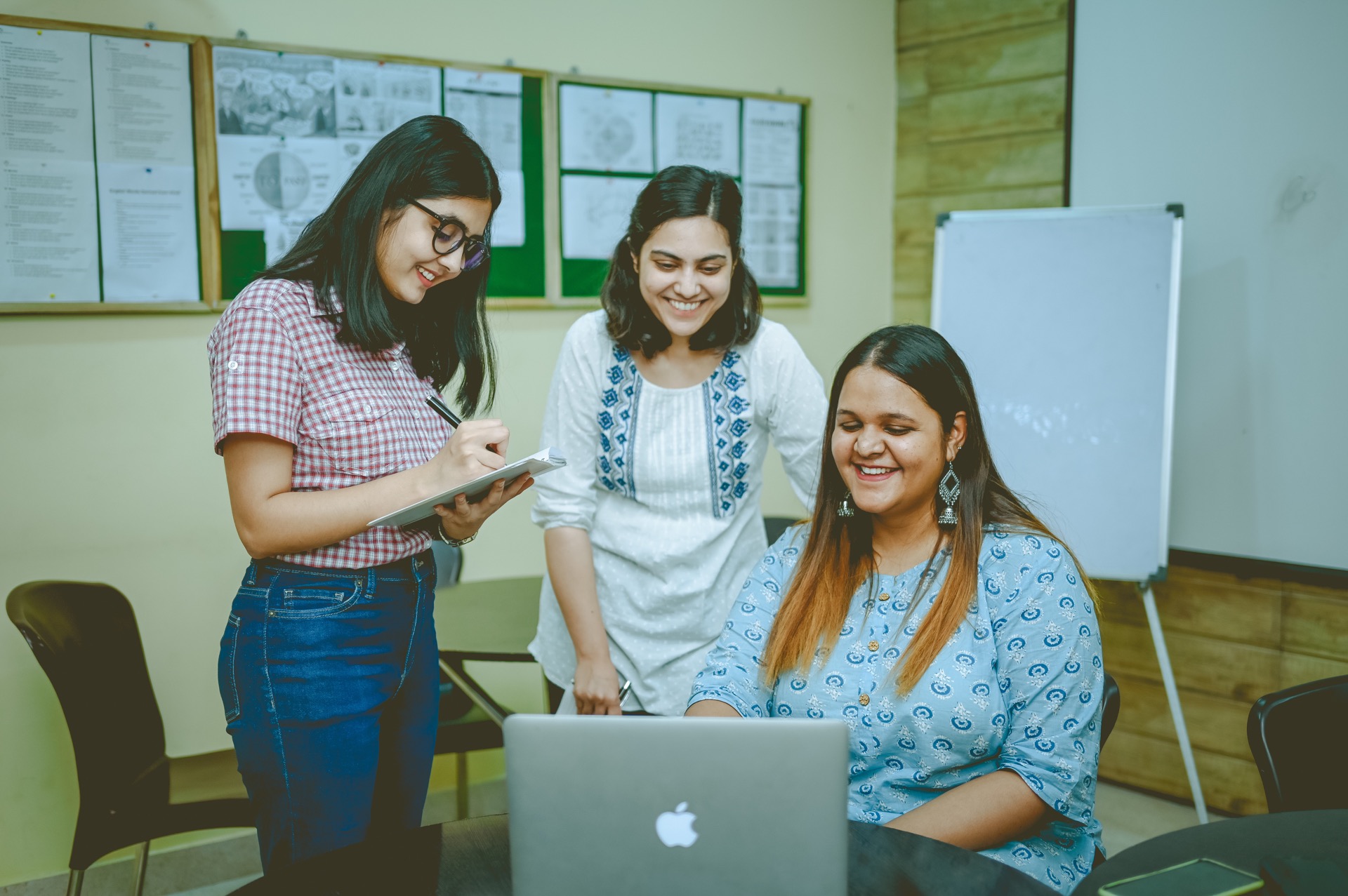 Students collaborating at a laptop